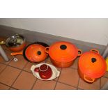 A GROUP OF LE CREUSET CAST IRON COOKWARES, to include an oval casserole dish, a large circular