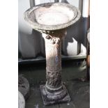A COMPOSITE BIRD BATH, on a pattered Corinthian column support with religious figures to bottom