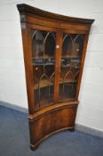 A REPRODUX MAHOGANY GLAZED CONCAVE TWO DOOR CORNER CUPBOARD, above double cupboard doors, width 92cm