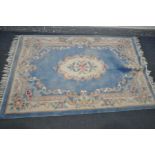 A WOOLLEN BLUE CHINESE RUG, 182cm x 124cm