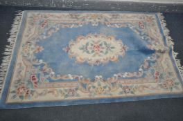 A WOOLLEN BLUE CHINESE RUG, 182cm x 124cm