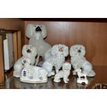 SIX VICTORIAN STAFFORDSHIRE WHITE GLAZED AND FRIT DECORATED POODLE FIGURES AND A SIMILAR SMALL