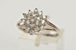 A 9CT WHITE GOLD BRILLIANT-CUT DIAMOND CLUSTER RING, with nineteen graduated diamonds to the