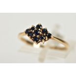 A 9CT GOLD SAPPHIRE CLUSTER RING, tiered cluster of a navette shape, set with nine circular cut deep
