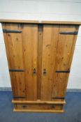 A SOLID PINE DOUBLE DOOR WARDROBE, with iron hinges and handles, and a single long drawer, width