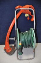 A FLYMO REVOLUTION 2500 STRIMMER (PAT pass and working) and a portable hose reel (2)