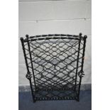 A WROUGHT IRON WINE RACK, with four ball finials on barley twist supports and open twisted sections,
