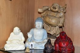 SIX MODERN WOODEN, PORCELAIN AND RESIN BUDDHA FIGURES, including a wooden buddha with one raised