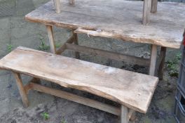 A RUSTIC LIVE EDGE GARDEN TABLE, length 124cm x depth 65cm x height 72cm, and two sized benches, max
