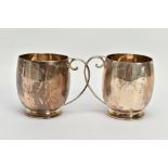 A PAIR OF SILVER CUPS, each of a plain polished design, personal engraving reads 'M.C & M.T.G.S