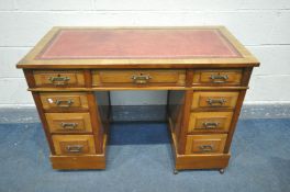 A LATE 19TH/EARLY 20TH CENTURY WALNUT PEDESTAL DESK, with a red leather writing surface, and an