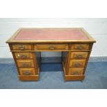 A LATE 19TH/EARLY 20TH CENTURY WALNUT PEDESTAL DESK, with a red leather writing surface, and an