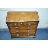 A GEORGIAN OAK FALL FRONT BUREAU, the inside with eight various drawers, two pen holders, a