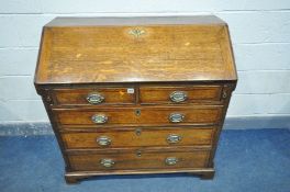 A GEORGIAN OAK FALL FRONT BUREAU, the inside with eight various drawers, two pen holders, a