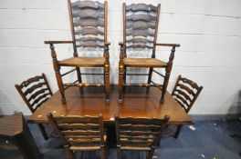 A REPRODUCTION OAK DRAW LEAF DINING TABLE, on trestle legs united by a single stretcher, open length