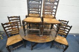 A GEORGIAN OAK OVAL GATE LEG TABLE, with a single drawer at each end, open length 154cm x closed