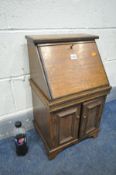 A MINITURE OAK BUREAU, width 35cm x depth 27cm x height 60cm, with key (condition:-loose left door)