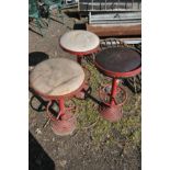 THREE ART DECO RED PAINTED METAL HIGH STOOLS, with a circular top, and footrest, on a stepped
