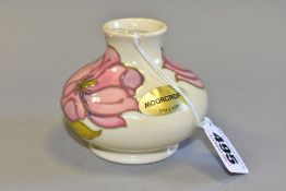 A MOORCROFT POTTERY SQUAT VASE DECORATED WITH PINK HIBISCUS, on a cream ground, gold factory sticker