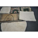 SEVEN VARIOUS RUGS, to include a large beige ground rig with blue border, a pair of green rugs,