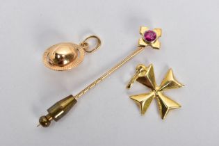 TWO YELLOW METAL CHARMS AND A STICK PIN, to include a puffy Maltese cross charm fitted with an