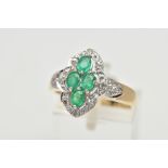 A 9CT YELLOW AND WHITE GOLD EMERALD AND DIAMOND DRESS RING, set with four oval cut emeralds,