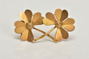 A YELLOW METAL BROOCH, designed as a double four leaf clover, stamped to the reverse 15ct, fitted