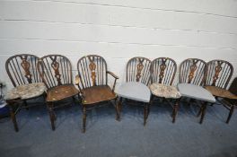 A SET OF SEVEN ELM AND BEECH HOOP BACK CHAIRS, including one carver condition:-fluid staining to