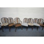A SET OF SEVEN ELM AND BEECH HOOP BACK CHAIRS, including one carver condition:-fluid staining to