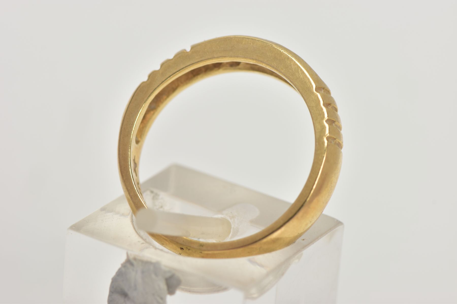 A YELLOW METAL DIAMOND RING, wide band measuring approximately 4.7mm, designed with a row of channel - Image 3 of 4