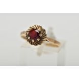 A 9CT YELLOW GOLD GARNET SINGLE STONE RING, set with a circular cut garnet, within a textured