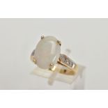 A 9CT GOLD OPAL AND DIAMOND DRESS RING, four claw set white opal cabochon showing flashes of blue,