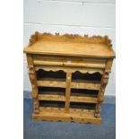 A LATE 20TH PINE DRINKS AND BOTTLE DISPLAY CABINET, with carved raised back, and a single drawer,