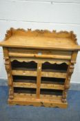 A LATE 20TH PINE DRINKS AND BOTTLE DISPLAY CABINET, with carved raised back, and a single drawer,