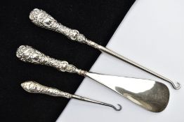 TWO SILVER HANDLED BUTTON HOOKS AND A SILVER HANDLED SHOE HORN, a button hook and shoe horn silver