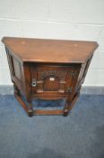 A LATE 20TH CENTURY OAK SINGLE DOOR CREDENCE CABINET, with carved panel door, width 81cm x depth