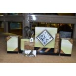 A FRENCH ART DECO CLOCK GARNITURE, of asymmetric geometric form, the coloured marble case surmounted