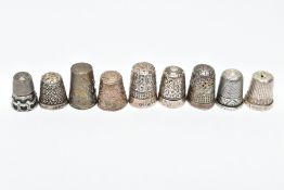 AN ASSORTMENT OF SILVER AND WHITE METAL THIMBLES, five decorative silver thimbles, each hallmarked