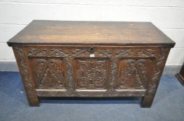 A GEORGIAN CARVED OAK PANELLED COFFER, width 124cm x depth 56cm x height 70cm (condition:-historical