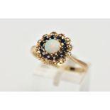 A 9CT YELLOW GOLD SAPPHIRE AND OPAL CLUSTER RING, set with a principal opal cabochon, surrounded