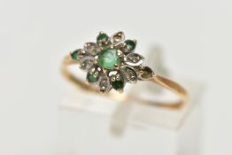 A 9CT YELLOW GOLD EMERALD AND DIAMOND CLUSTER RING, set with a circular cut emerald, within an