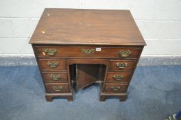 A GEORGIAN STYLE MAHOGANY KNEE HOLE DESK, with a single long drawer, over two banks of three drawers