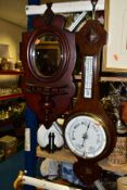A MAHOGANY WALL MIRROR WITH SHELF AND A BAROMETER, the wall mirror having oval bevelled glass set in