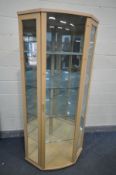 A BEECH CORNER DISPLAY CABINET, enclosing four glass shelves and two mirrored backs, width 92cm x