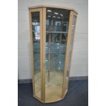 A BEECH CORNER DISPLAY CABINET, enclosing four glass shelves and two mirrored backs, width 92cm x