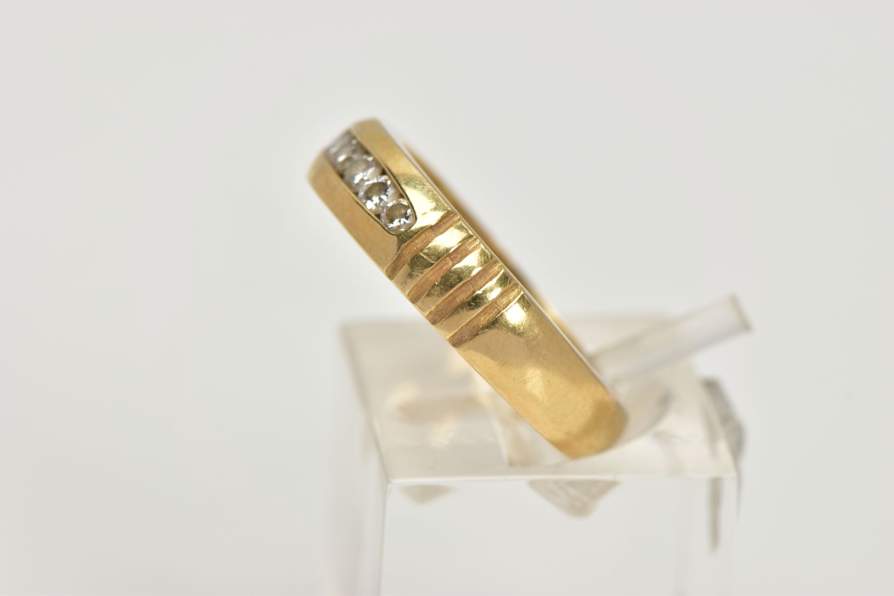 A YELLOW METAL DIAMOND RING, wide band measuring approximately 4.7mm, designed with a row of channel - Image 2 of 4