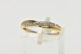 A 9CT YELLOW GOLD DIAMOND CROSSOVER BAND RING, set with thirteen single cut diamonds, claw set to