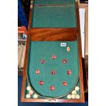 A VICTORIAN MAHOGANY CASED, 'BAGATELLE' BOARD, brass hinged, length 1.27m when opened, with nine