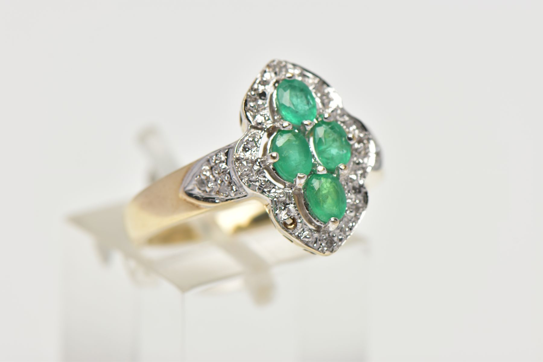 A 9CT YELLOW AND WHITE GOLD EMERALD AND DIAMOND DRESS RING, set with four oval cut emeralds, - Image 4 of 4