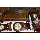 SIX LATE 19TH AND 20TH CENTURY WALL CLOCKS AND CASES, including a late 19th century walnut and
